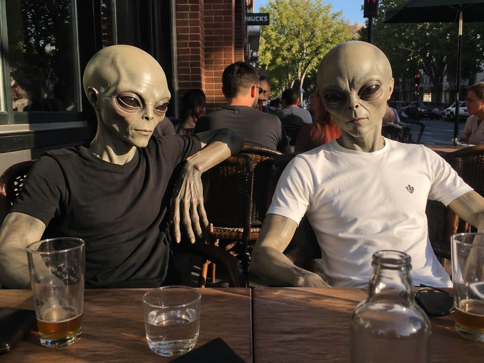 A photorealistic i Phone photo of two aliens sitting at an outdoor cafe generated with gpt image 2 on clipfly