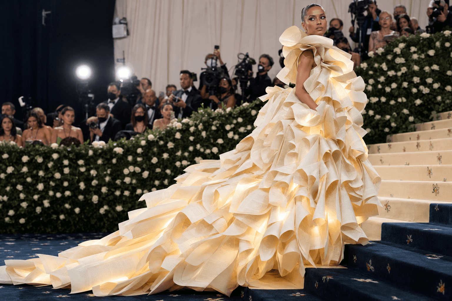 Paper couture in a hand folded paper gown on the met gala red carpet
