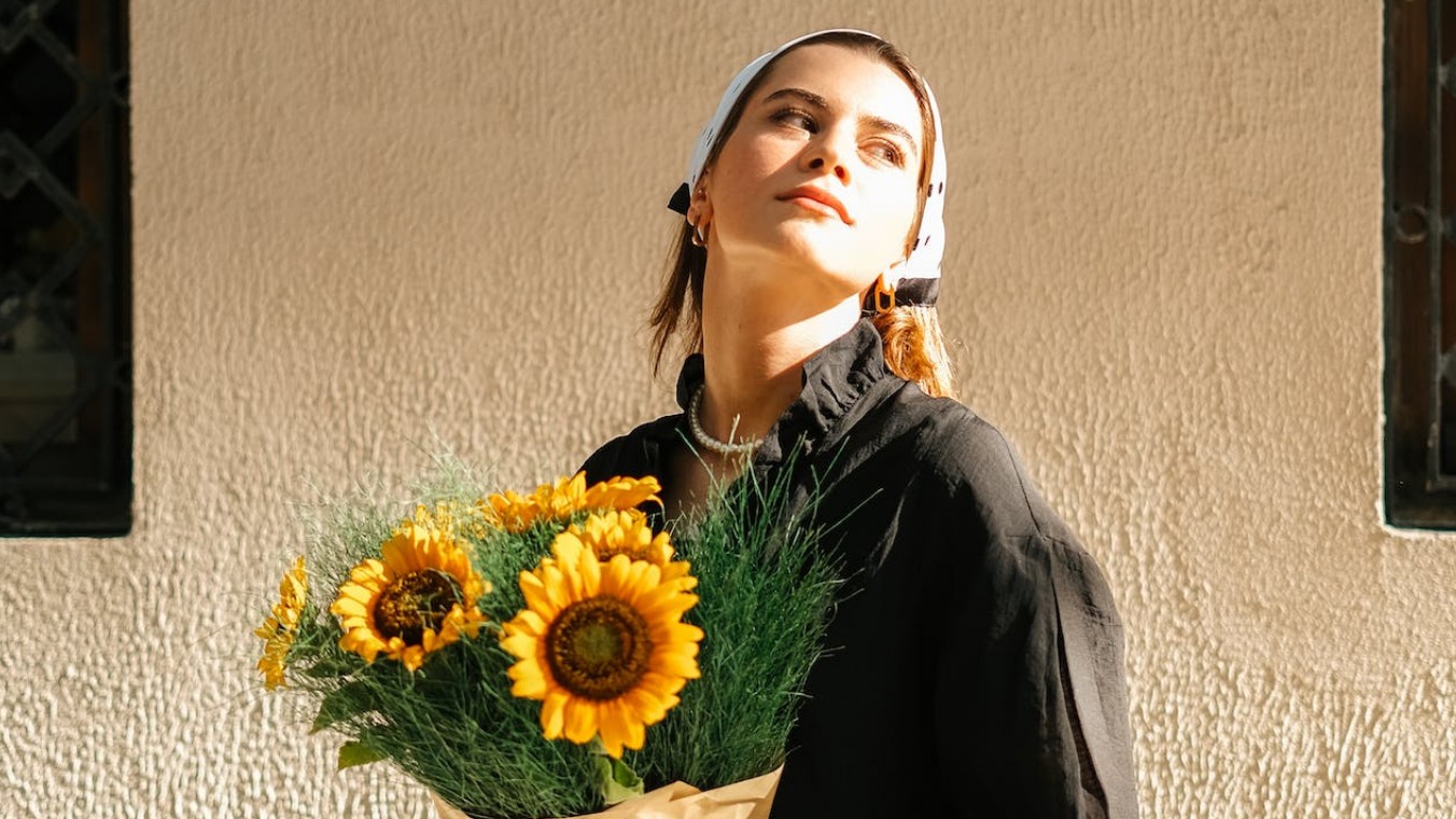 AI video unblur featuring a beautiful women with a bunch of sunflower
